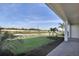 Relaxing backyard view of the pond and lush landscaping from the covered patio at 17915 Palmiste Dr, Bradenton, FL 34202