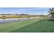 Picturesque view of a pond with lush lawn extending to the water's edge at 17915 Palmiste Dr, Bradenton, FL 34202