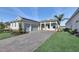 Charming single-Gathering home showcasing a lush landscaped yard and paver driveway at 17915 Palmiste Dr, Bradenton, FL 34202