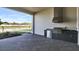 Covered outdoor kitchen featuring stainless steel appliances and brick flooring at 17915 Palmiste Dr, Bradenton, FL 34202