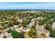 Scenic aerial view of a neighborhood with mature trees, showcasing a home with solar panels at 2822 Maple Ave, Sarasota, FL 34234