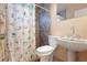 Cozy bathroom with stone shower, seashell curtain, pedestal sink, and a toilet at 2822 Maple Ave, Sarasota, FL 34234