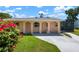 Charming home featuring an arched porch and a well-maintained lawn with mature landscaping and driveway at 2822 Maple Ave, Sarasota, FL 34234