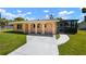 Inviting home exterior featuring a cozy front porch with arched entryways and a manicured lawn at 2822 Maple Ave, Sarasota, FL 34234