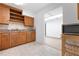 Kitchen with wooden cabinets, granite countertops, tile backsplash, and white appliances, open to a hallway at 2822 Maple Ave, Sarasota, FL 34234