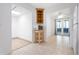 Bright kitchen featuring tile flooring, wooden shelving, and stainless steel microwave and white appliances at 2822 Maple Ave, Sarasota, FL 34234