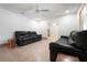 Bright living room featuring tile flooring, ceiling fan, and leather sofa set at 2822 Maple Ave, Sarasota, FL 34234