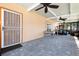 Spacious screened patio with tile floors, ceiling fans, and access to the backyard and other areas of the home at 2822 Maple Ave, Sarasota, FL 34234