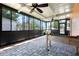 Relaxing sunroom features all-weather pavers and ceiling fans, perfect for year-round enjoyment at 2822 Maple Ave, Sarasota, FL 34234