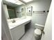 Clean bathroom featuring white vanity, sink, toilet, and medicine cabinet at 315 30Th W Ave # 101B, Bradenton, FL 34205