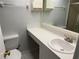 Bathroom with a white vanity, sink, and toilet with mirror at 315 30Th W Ave # 101B, Bradenton, FL 34205