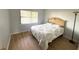 Bright bedroom features a large window, neutral walls, and wood-look flooring at 315 30Th W Ave # 101B, Bradenton, FL 34205