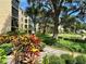 Lush community grounds featuring a serene pond, vibrant landscaping, and mature trees, creating a tranquil environment at 315 30Th W Ave # 101B, Bradenton, FL 34205