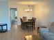 Inviting dining area connected to the living space, featuring a classic chandelier and seating for memorable gatherings at 315 30Th W Ave # 101B, Bradenton, FL 34205