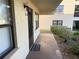 Condo exterior showcasing a private entryway with a door mat and adjacent landscaping at 315 30Th W Ave # 101B, Bradenton, FL 34205