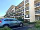 Exterior of building with multiple floors and balconies in the Village B community with manicured landscape at 315 30Th W Ave # 101B, Bradenton, FL 34205