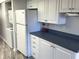 A compact kitchen space with stacked washer/dryer, refrigerator, and ample cabinet storage at 315 30Th W Ave # 101B, Bradenton, FL 34205