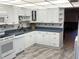Bright kitchen featuring white cabinetry, blue countertops, and modern appliances at 315 30Th W Ave # 101B, Bradenton, FL 34205