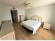 Comfortable bedroom featuring wood floors, wicker furniture, and a ceiling fan at 315 30Th W Ave # 101B, Bradenton, FL 34205