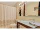Bathroom with a white patterned shower curtain, a mirror, and a modern sink at 4147 Augustine Ave, Sarasota, FL 34231