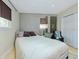 Cozy bedroom with a full-size bed, a chair, neutral colored window shades, and a closet at 4147 Augustine Ave, Sarasota, FL 34231