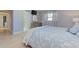 Bedroom with a king-size bed, light blue bedding, a dresser, and a TV on the wall at 4147 Augustine Ave, Sarasota, FL 34231