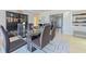 Open dining room with a glass table, modern chairs, and view of the living spaces at 4147 Augustine Ave, Sarasota, FL 34231