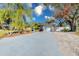 Wide driveway leading to a well-maintained single-story home with mature landscaping at 4147 Augustine Ave, Sarasota, FL 34231