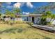 Charming home featuring a well-manicured front lawn and mature palm trees at 4147 Augustine Ave, Sarasota, FL 34231