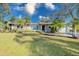 Charming single-story home with a well-manicured lawn, mature trees, and lush landscaping at 4147 Augustine Ave, Sarasota, FL 34231