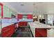 Contemporary kitchen with red cabinets, a center island, modern lighting, and open layout at 4147 Augustine Ave, Sarasota, FL 34231