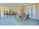 Enclosed lanai offering a dining area and additional seating with tranquil outdoor views at 4147 Augustine Ave, Sarasota, FL 34231