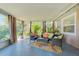 Relaxing sunroom with ample seating and lush greenery, perfect for enjoying the outdoors at 4147 Augustine Ave, Sarasota, FL 34231