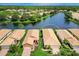 Aerial view of a beautiful single Gathering home with tile roof and lush landscaping on lakefront property at 4244 Reflections Pkwy, Sarasota, FL 34233