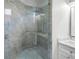 Modern bathroom showcasing a glass-enclosed shower with gray marble-style tile at 4244 Reflections Pkwy, Sarasota, FL 34233