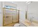 Bathroom featuring shower with gold sliding doors, tile flooring, and modern vanity at 4244 Reflections Pkwy, Sarasota, FL 34233