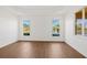 Bright bedroom with wood floors, tray ceiling, and stunning views of the lake at 4244 Reflections Pkwy, Sarasota, FL 34233
