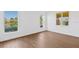 Sunny bedroom with wood floors and views of the lake and lush landscaping at 4244 Reflections Pkwy, Sarasota, FL 34233