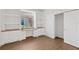 Bedroom with hardwood floors, desk, built-in shelves, and walk-in closet at 4244 Reflections Pkwy, Sarasota, FL 34233