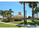 A community pool with lounge chairs and well-manicured landscaping on a sunny day with a blue sky at 4244 Reflections Pkwy, Sarasota, FL 34233