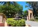 The beautiful water fountain in the entry way has lion statues and is surrounded by green bushes and red mulch at 4244 Reflections Pkwy, Sarasota, FL 34233