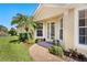 A charming brick entryway with mature landscaping leading to a decorative glass front door at 4244 Reflections Pkwy, Sarasota, FL 34233