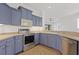A kitchen featuring stainless steel appliances and unique blue cabinetry, offering a stylish and modern cooking space at 4244 Reflections Pkwy, Sarasota, FL 34233