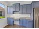 Updated kitchen featuring blue cabinets, lots of storage, and a breakfast bar at 4244 Reflections Pkwy, Sarasota, FL 34233