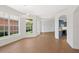 Spacious living room with large windows providing ample natural light and a view of the backyard, seamlessly connecting to the kitchen at 4244 Reflections Pkwy, Sarasota, FL 34233
