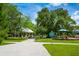 Community park featuring walking paths, benches, a picnic shelter, and a playground under a sunny, partly cloudy sky at 4244 Reflections Pkwy, Sarasota, FL 34233