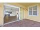 A covered patio space with brick flooring and a view into a blue kitchen through large sliding glass doors at 4244 Reflections Pkwy, Sarasota, FL 34233