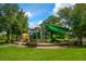Community playground featuring climbing structures, slides, and shaded seating areas for residents to enjoy at 4244 Reflections Pkwy, Sarasota, FL 34233
