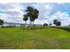 Expansive green space, palm trees, and pond offer a serene view of the condos in this waterfront community at 4722 Independence Dr, Bradenton, FL 34210