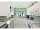Bright kitchen with white cabinets, granite countertops, stainless steel appliances, and a window over the sink at 4722 Independence Dr, Bradenton, FL 34210